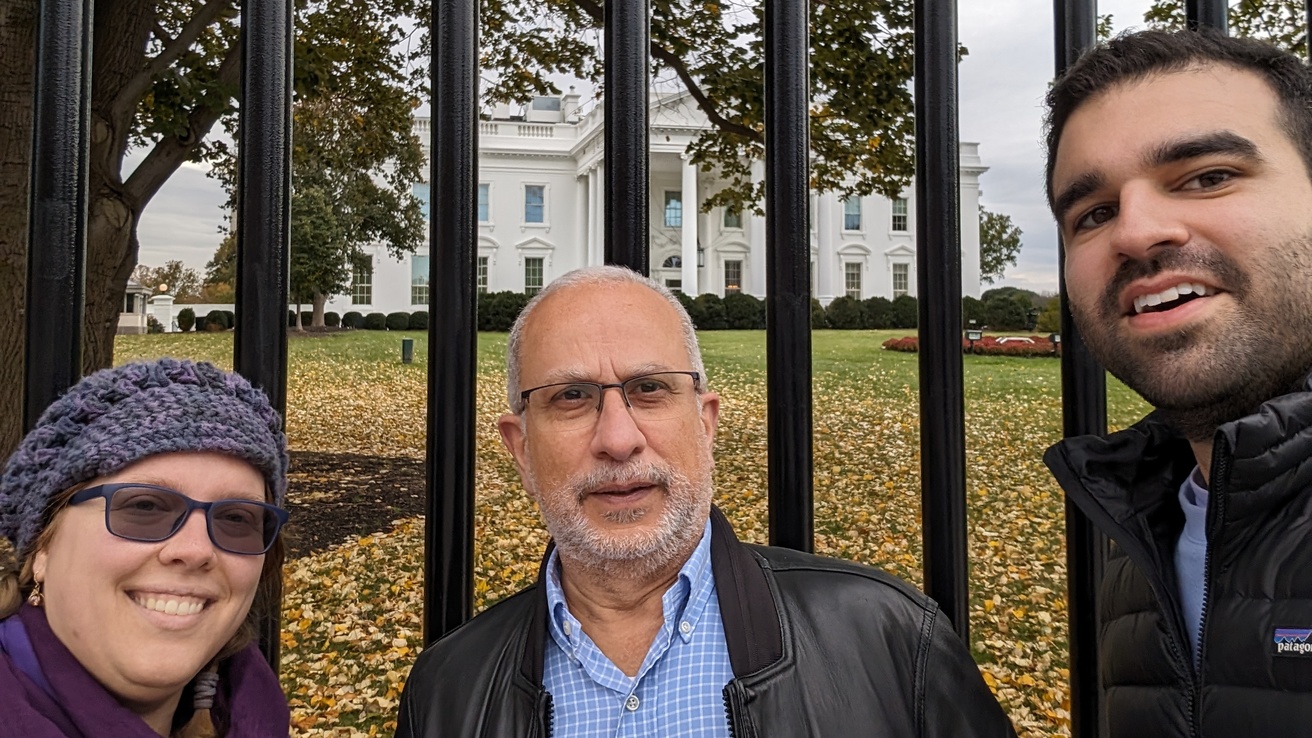 Three lab members in front of the white house